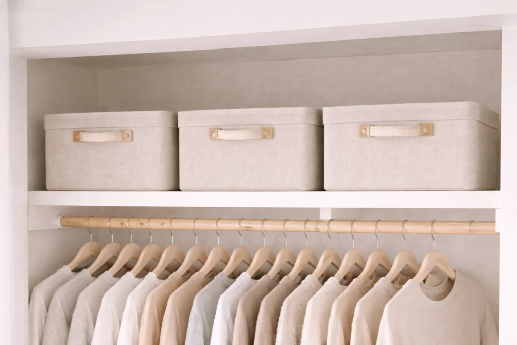 Matching neutral storage boxes on a top closet shelf